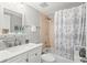 Bathroom featuring a white vanity, tub with shower, and updated fixtures at 2700 Ocean Shore Blvd # 508, Ormond Beach, FL 32176