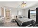 Grey bedroom with a bed, dresser, and view into another bathroom at 2700 Ocean Shore Blvd # 508, Ormond Beach, FL 32176