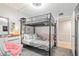 Bunk bed in a well-lit bedroom with a dresser and gray carpeting at 2700 Ocean Shore Blvd # 508, Ormond Beach, FL 32176