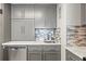 Modern kitchen with gray cabinets, quartz countertops, and a stylish backsplash at 2700 Ocean Shore Blvd # 508, Ormond Beach, FL 32176