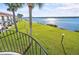 Balcony overlooking the waterfront with views of the community grounds and palm trees at 53 Ocean Palm Villa S # 53, Flagler Beach, FL 32136