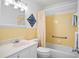 Bathroom with yellow tile, white vanity, and shower/tub combo at 53 Ocean Palm Villa S # 53, Flagler Beach, FL 32136