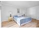 Bedroom with blue striped bedspread, light wood-look floors, and white walls at 53 Ocean Palm Villa S # 53, Flagler Beach, FL 32136