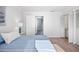 Spacious bedroom with wood-look flooring, a vanity area, and access to another room at 53 Ocean Palm Villa S # 53, Flagler Beach, FL 32136