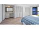Bedroom with built-in vanity, closet doors, wood-look floors, and balcony access at 53 Ocean Palm Villa S # 53, Flagler Beach, FL 32136