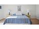 Bright and airy bedroom with blue and white striped bedding and laminate flooring at 53 Ocean Palm Villa S # 53, Flagler Beach, FL 32136