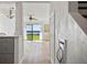Entryway with wood-look flooring, textured walls, and a view of the living area and waterfront at 53 Ocean Palm Villa S # 53, Flagler Beach, FL 32136