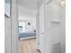 Hallway leading to a bedroom with light wood-look flooring and white walls at 53 Ocean Palm Villa S # 53, Flagler Beach, FL 32136