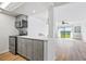 Kitchen with stainless steel appliances, gray cabinets, and view of the living room at 53 Ocean Palm Villa S # 53, Flagler Beach, FL 32136