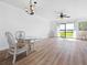 Spacious living area with wicker furniture, ceiling fan, and sliding glass doors at 53 Ocean Palm Villa S # 53, Flagler Beach, FL 32136