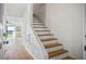 Wooden staircase with white risers and textured walls leading to the main living area at 53 Ocean Palm Villa S # 53, Flagler Beach, FL 32136
