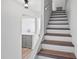 Stairway with wood treads and white risers leading to the second floor at 53 Ocean Palm Villa S # 53, Flagler Beach, FL 32136