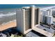 Aerial view of beachfront condo building, parking below at 89 S Atlantic Ave # 1401, Ormond Beach, FL 32176