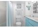 Bright bathroom with teal vanity, shower/tub combo, and beachy decor at 89 S Atlantic Ave # 1401, Ormond Beach, FL 32176