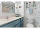 Clean bathroom with teal vanity and shower at 89 S Atlantic Ave # 1401, Ormond Beach, FL 32176