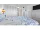 Bedroom with coastal bedding and built-in closets at 89 S Atlantic Ave # 1401, Ormond Beach, FL 32176