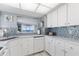 Updated kitchen featuring white cabinets, granite countertops, and ocean view at 89 S Atlantic Ave # 1401, Ormond Beach, FL 32176