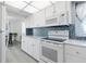 White kitchen with stainless steel appliances and ocean view at 89 S Atlantic Ave # 1401, Ormond Beach, FL 32176