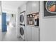 Compact laundry area with stacked washer and dryer at 89 S Atlantic Ave # 1401, Ormond Beach, FL 32176