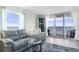 Spacious living room, featuring ocean view and gray couches at 89 S Atlantic Ave # 1401, Ormond Beach, FL 32176