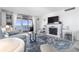 Bright living room with ocean view, fireplace, and comfy seating at 89 S Atlantic Ave # 1401, Ormond Beach, FL 32176