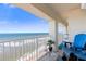 Ocean view from condo balcony with blue adirondack chairs at 89 S Atlantic Ave # 1401, Ormond Beach, FL 32176