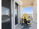 Tranquil balcony with ocean view and yellow adirondack chair at 89 S Atlantic Ave # 1401, Ormond Beach, FL 32176