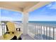 Breathtaking ocean view from a condo balcony, yellow adirondack chairs at 89 S Atlantic Ave # 1401, Ormond Beach, FL 32176