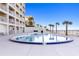 Heated oceanfront pool with lounge chairs at 89 S Atlantic Ave # 1401, Ormond Beach, FL 32176