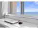 Ocean view workspace with laptop and mouse at 89 S Atlantic Ave # 1401, Ormond Beach, FL 32176