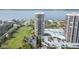 Aerial view of luxury waterfront condo building with pool and golf course views at 1 Oceans West Blvd # 5B3, Daytona Beach, FL 32118