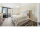 Bright bedroom with a king-size bed and balcony access at 1 Oceans West Blvd # 5B3, Daytona Beach, FL 32118
