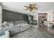 Living room with grey sectional sofa and ceiling fan at 1 Oceans West Blvd # 5B3, Daytona Beach, FL 32118