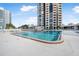 Condo complex pool with surrounding lounge chairs and building view at 1 Oceans West Blvd # 5B3, Daytona Beach, FL 32118