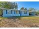 Light blue house with carport, and a well-maintained lawn at 1448 Richmond Ave, Daytona Beach, FL 32117