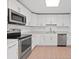 Modern kitchen with stainless steel appliances and white shaker cabinets at 1448 Richmond Ave, Daytona Beach, FL 32117