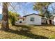 Back exterior view of a single story home with a large yard at 1703 Hill St, Edgewater, FL 32132