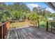 Wooden deck overlooks a backyard with lush greenery at 656 Winchester St, Daytona Beach, FL 32114