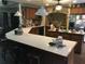 Large kitchen with a breakfast bar, brick accent wall, and stainless steel appliances at 2436 Cr 416N, Lake Panasoffkee, FL 33538