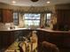 Spacious kitchen with wood cabinets, an island, and tile countertops at 2436 Cr 416N, Lake Panasoffkee, FL 33538