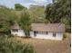 White single story house with brown roof, viewed from above at 9701 E Warm Springs Ave, Coleman, FL 33521