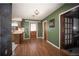 Kitchen with wood flooring, green walls, and door at 9701 E Warm Springs Ave, Coleman, FL 33521