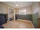 Bedroom featuring wood floors, a closet, and green and beige walls at 9701 E Warm Springs Ave, Coleman, FL 33521