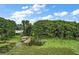Lakefront home with dock and boat lift, nestled among lush greenery at 31035 Cove Rd, Tavares, FL 32778