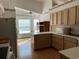 Open kitchen with light wood cabinets, an island, and views into the dining area at 25331 Hibiscus St, Leesburg, FL 34748