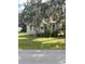 Small bungalow style home with stone foundation and lush landscaping at 5708 Se 109Th St, Belleview, FL 34420
