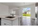 Kitchen with view to backyard; features island and stainless steel appliances at 429 Silver Palm Dr, Haines City, FL 33844
