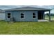 Home's back exterior with covered patio area at 429 Silver Palm Dr, Haines City, FL 33844