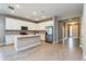 Modern kitchen with white cabinets, stainless steel appliances, and an island at 437 Silver Palm Dr, Haines City, FL 33844