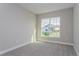 Bright bedroom with large window and carpet flooring at 437 Silver Palm Dr, Haines City, FL 33844